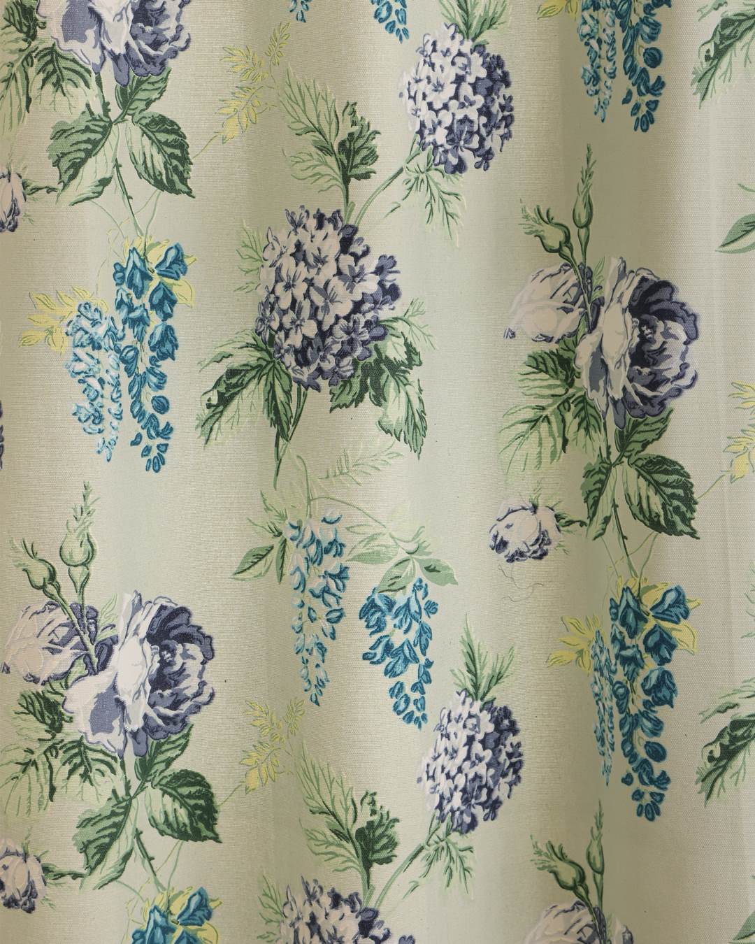 Texture detail of duck cotton fabric on sage green floral curtains